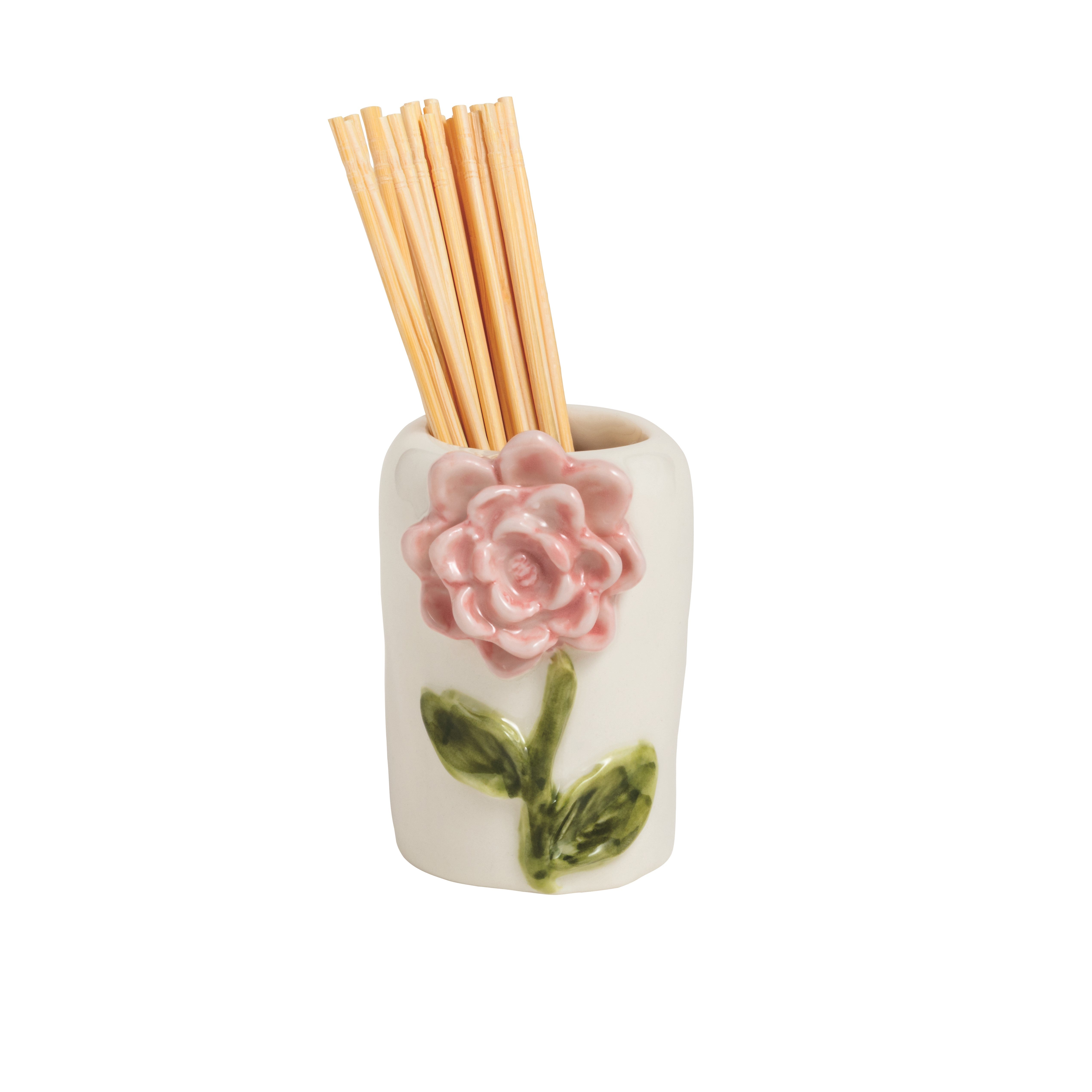 Ceramic holder with a pink rose design containing wooden sticks on a white background