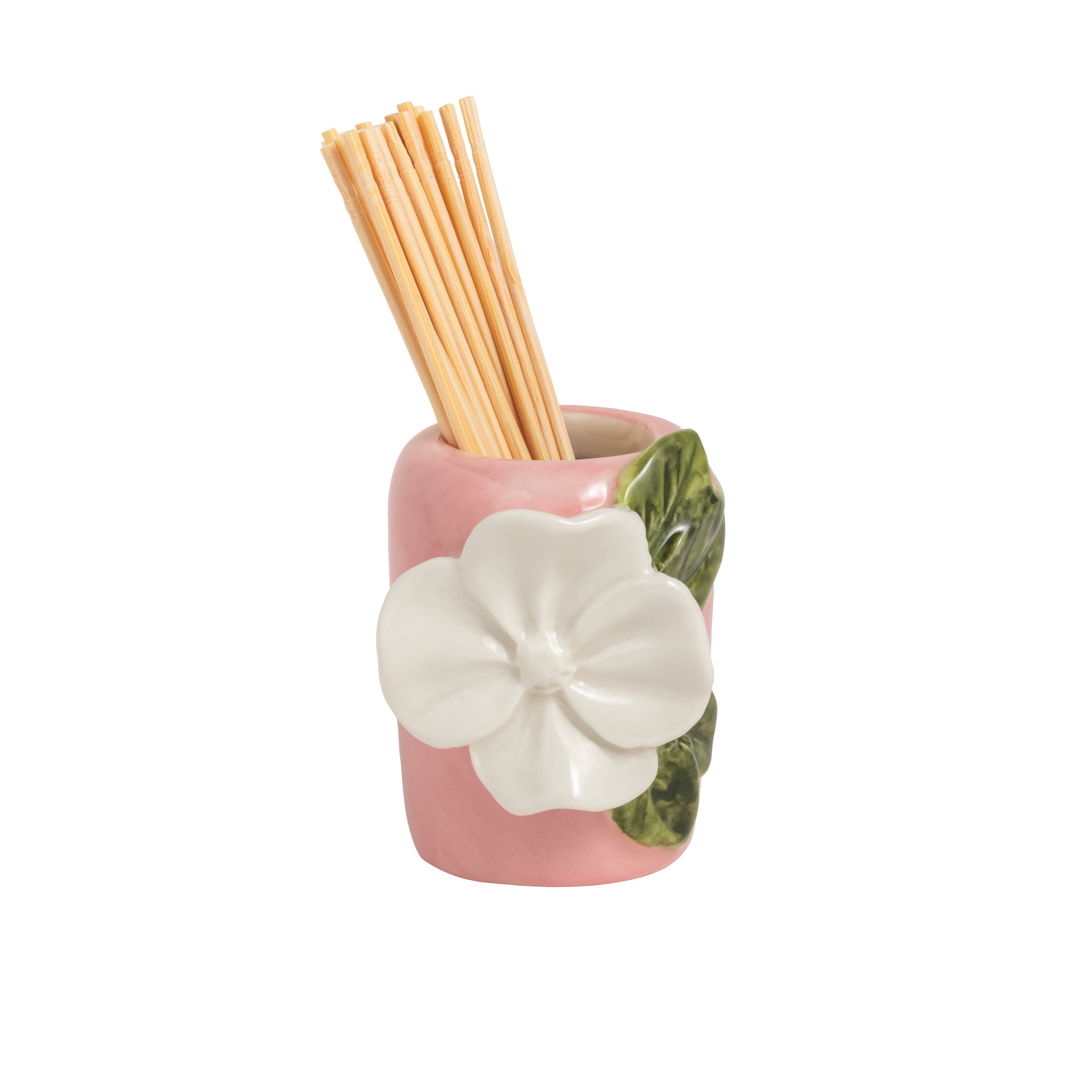 Pink ceramic holder with a white flower design containing wooden sticks on a white background