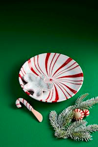 Decorative candy dish with peppermint pattern on a green background