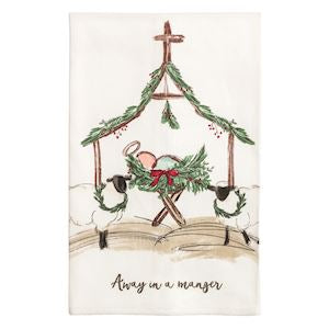Decorative towel with Christmas scene of baby Jesus in a manger, surrounded by sheep and an angel, on a white background.