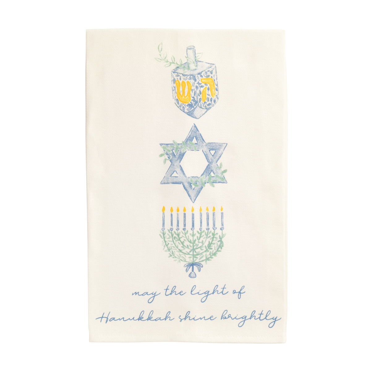 An off-white fabric tea towel featuring a vertical graphic of a blue and yellow Hanukkah dreidel, Star of David, and menorah with green leaves, above the cursive blue text 'may the light of Hanukkah shine brightly'.