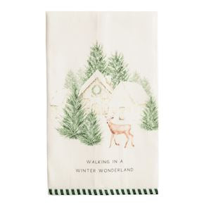 An off-white tea towel featuring a watercolor winter scene with pine trees, a small house, a deer, and the text 'WALKING IN A WINTER WONDERLAND'.