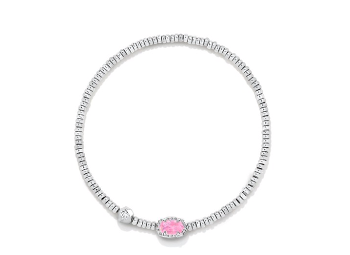 A silver-toned beaded bracelet featuring a central oval pink gemstone surrounded by a small halo of clear stones, set against a plain white background.
