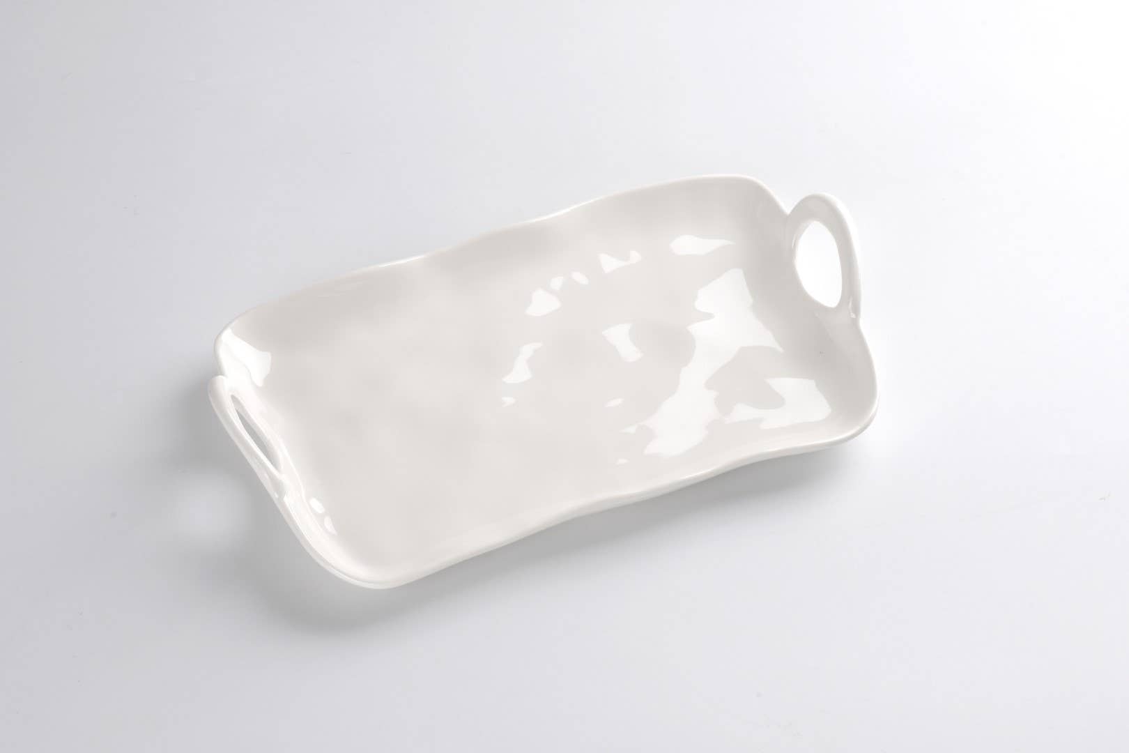 White melamine tray with a handle on a light gray background