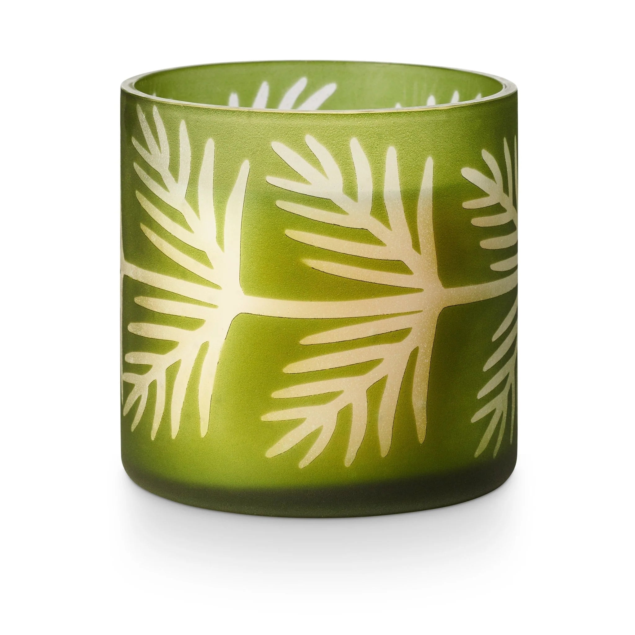Green glass candle holder with white leaf pattern on a white background