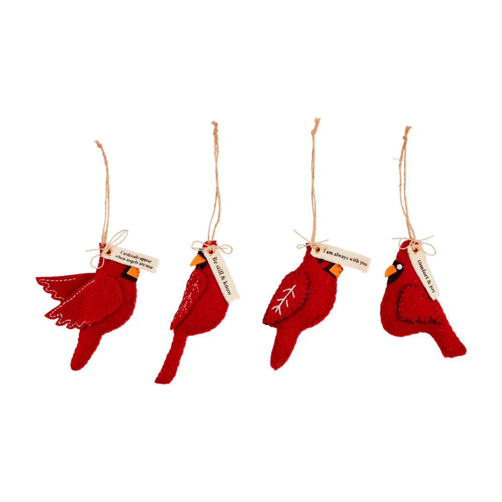 Four red cardinal bird ornaments with tags on a white background