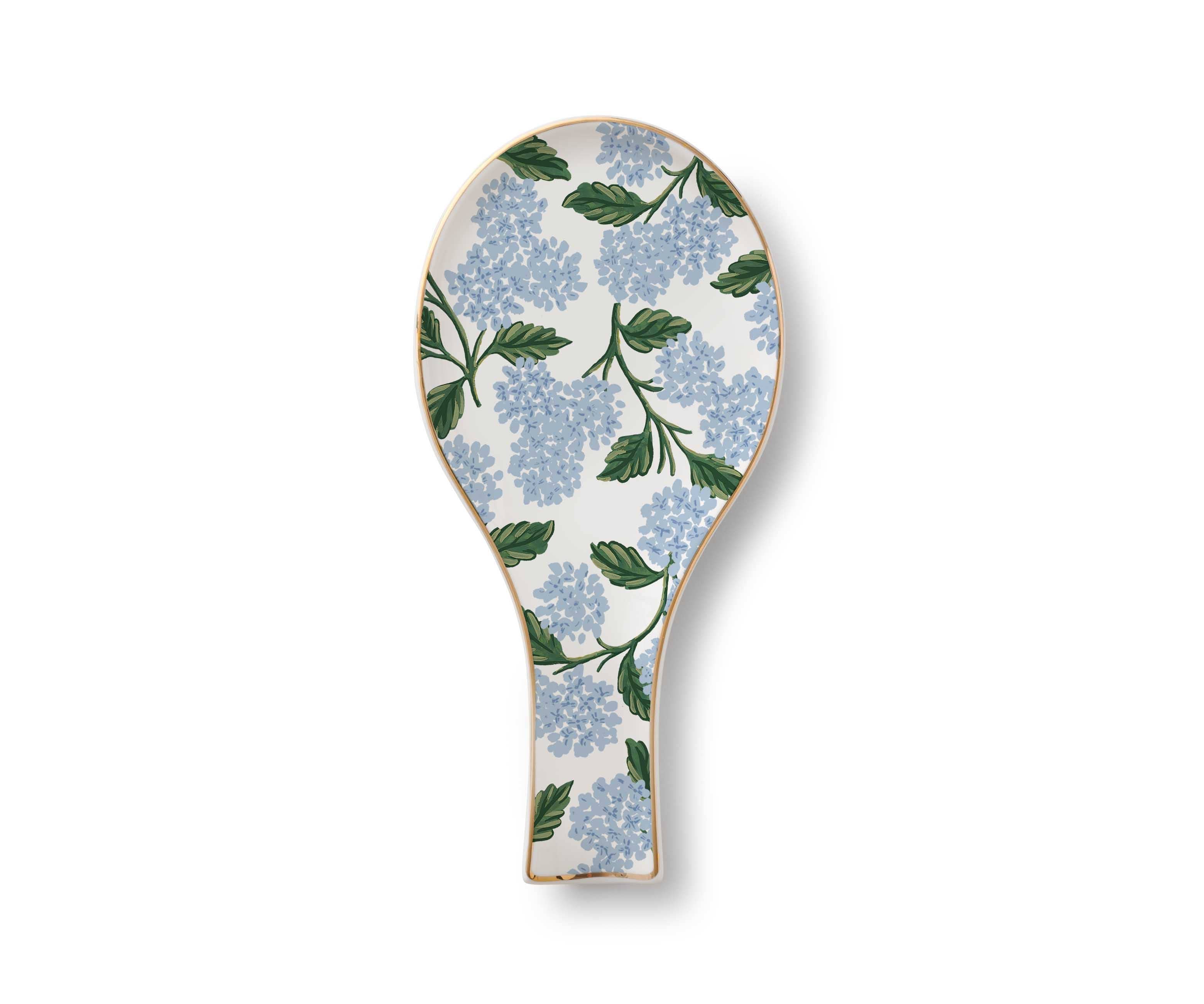 Decorative paddle with blue floral pattern on a white background