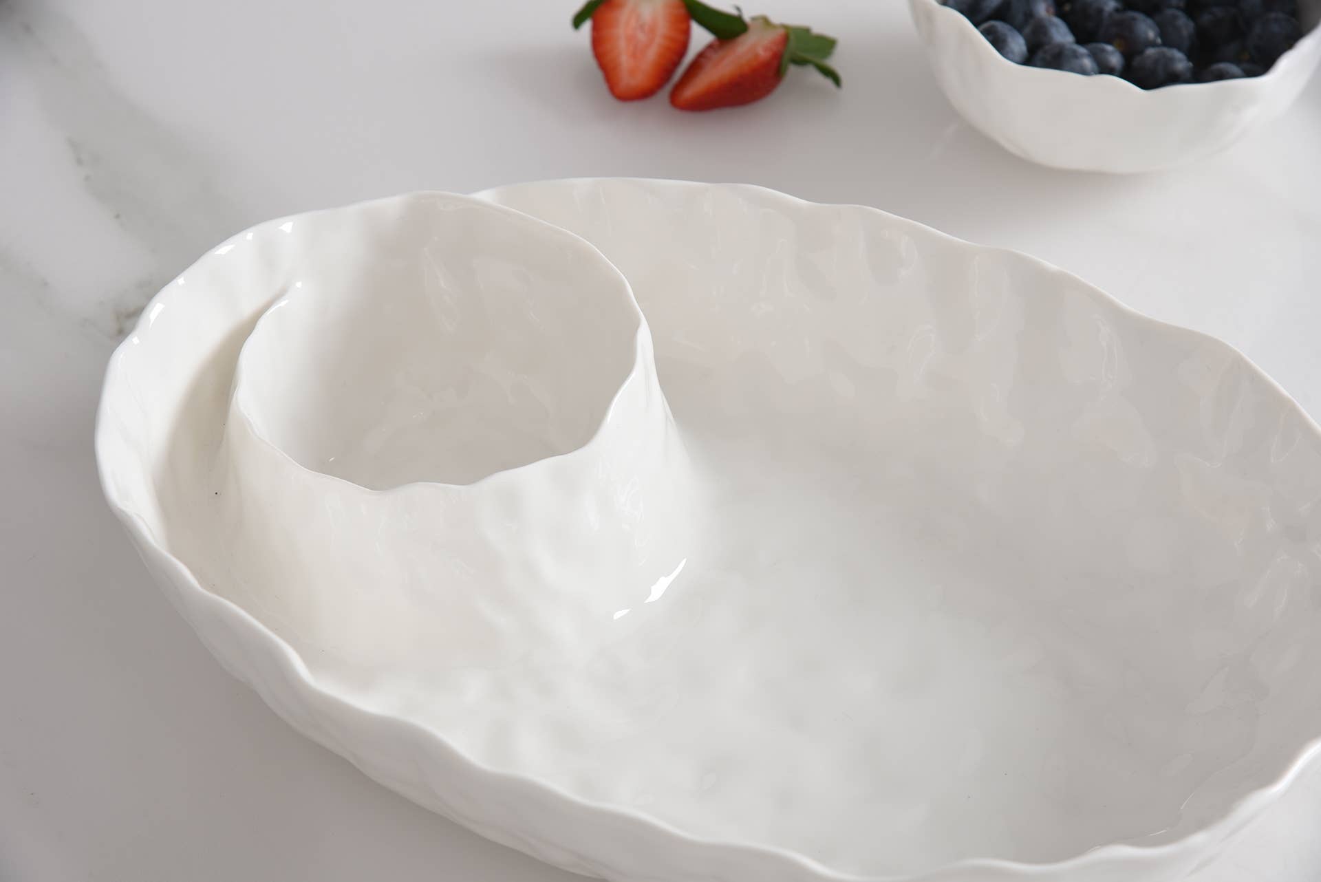 White ceramic dish with wavy edges on a light background