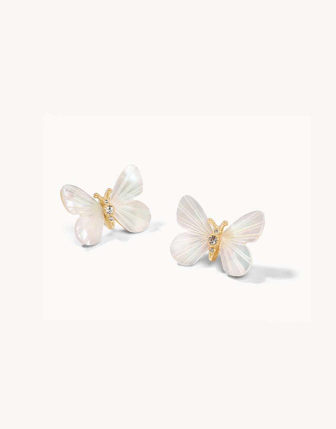 Butterfly-shaped earrings with gold accents on a white background