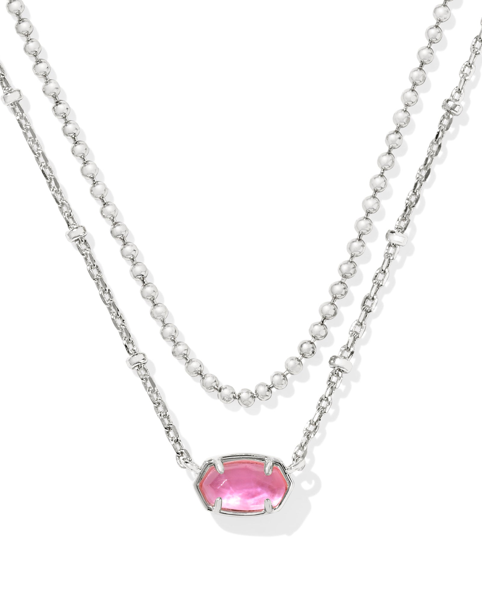 A double-strand silver necklace featuring a delicate beaded chain and a longer chain with a small pink gemstone pendant, set against a plain white background.