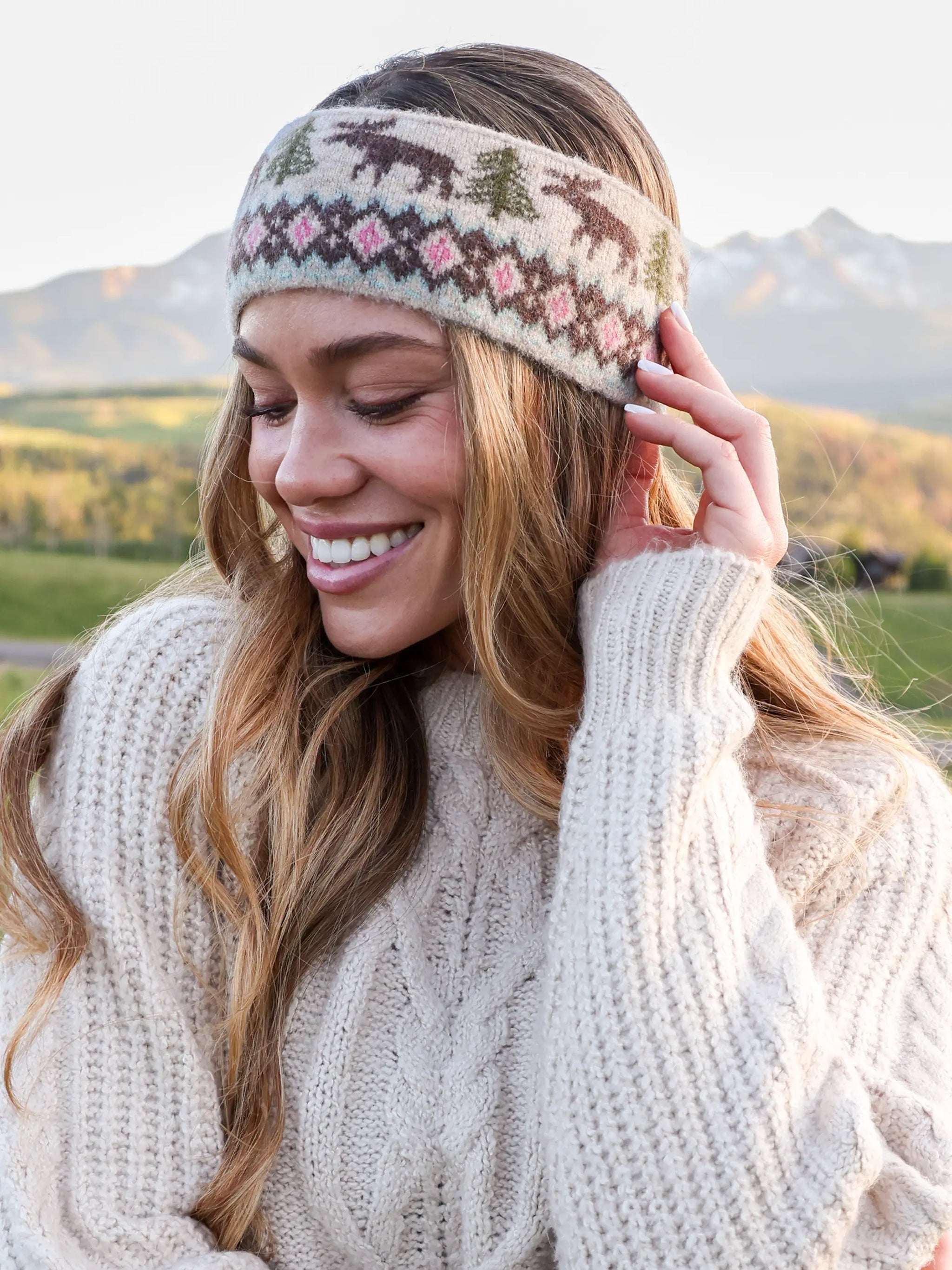 Woman wearing a patterned headband with mountains in the background