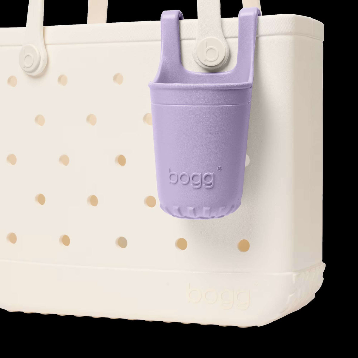 White tote bag with gold polka dots and a purple bogg bag holder on a white background