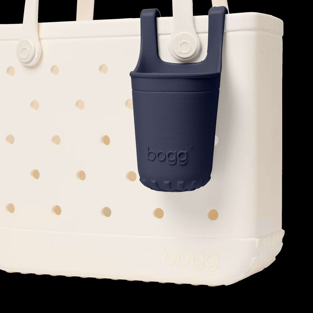 White tote bag with gold polka dots and a navy blue bogg bag attached on a white background