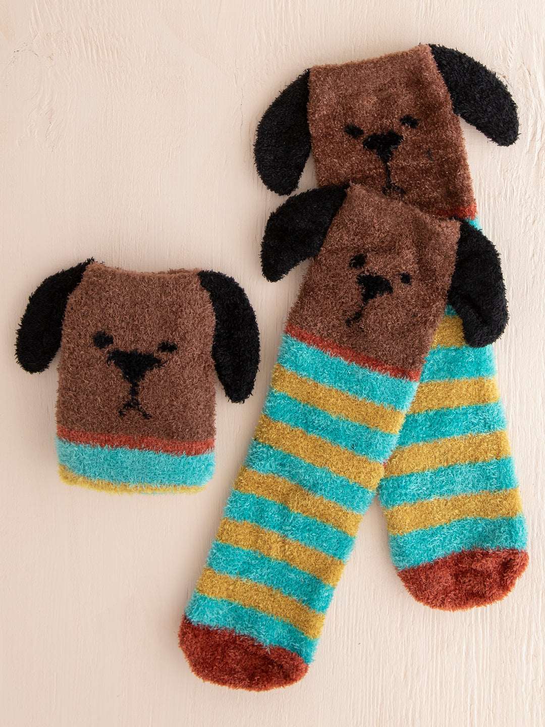 Pair of dog-shaped socks with striped pattern on a beige background