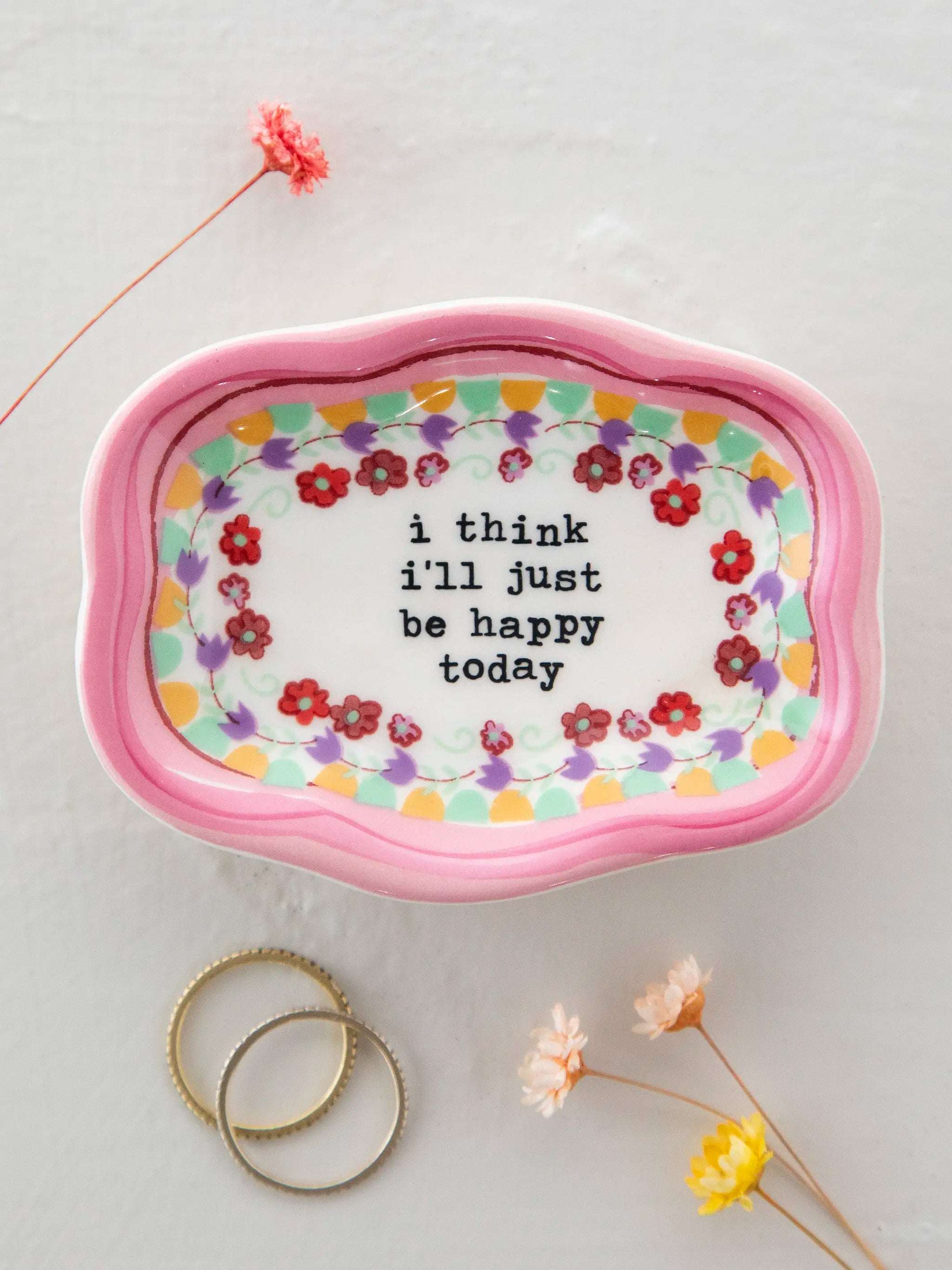Decorative tray with floral border and text 'i think i'll just be happy today' on a light background.