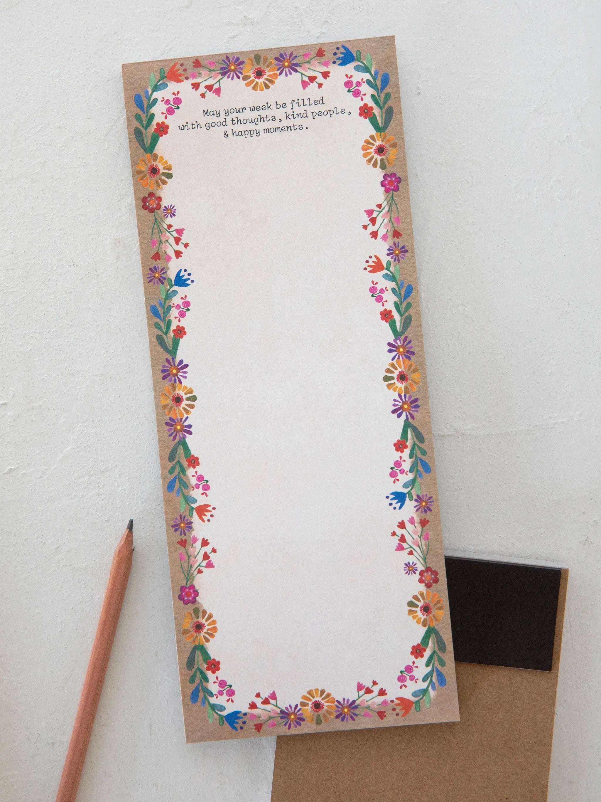 Floral border notepad with a pencil on a white background