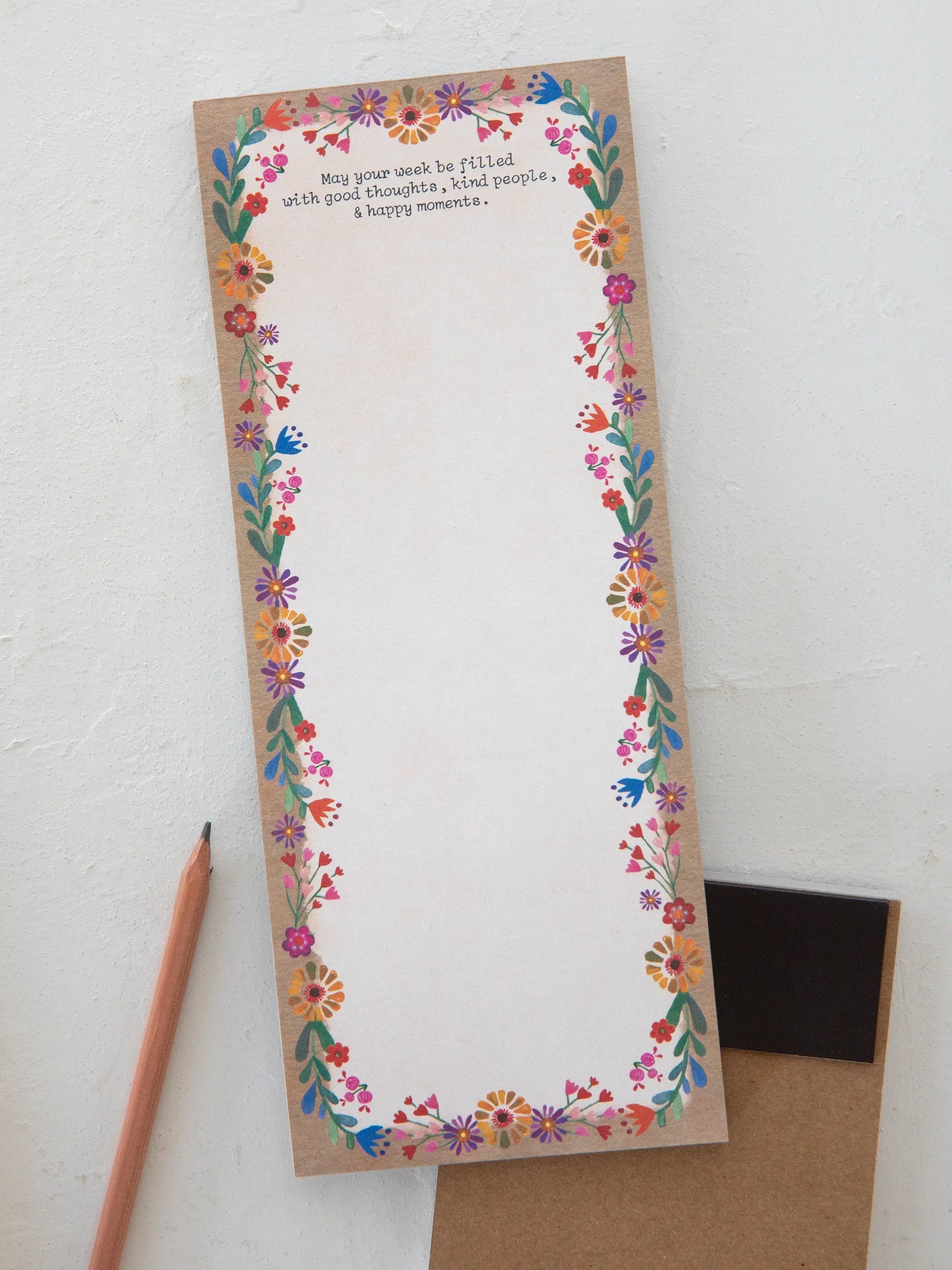 Floral border notepad with a pencil on a white background