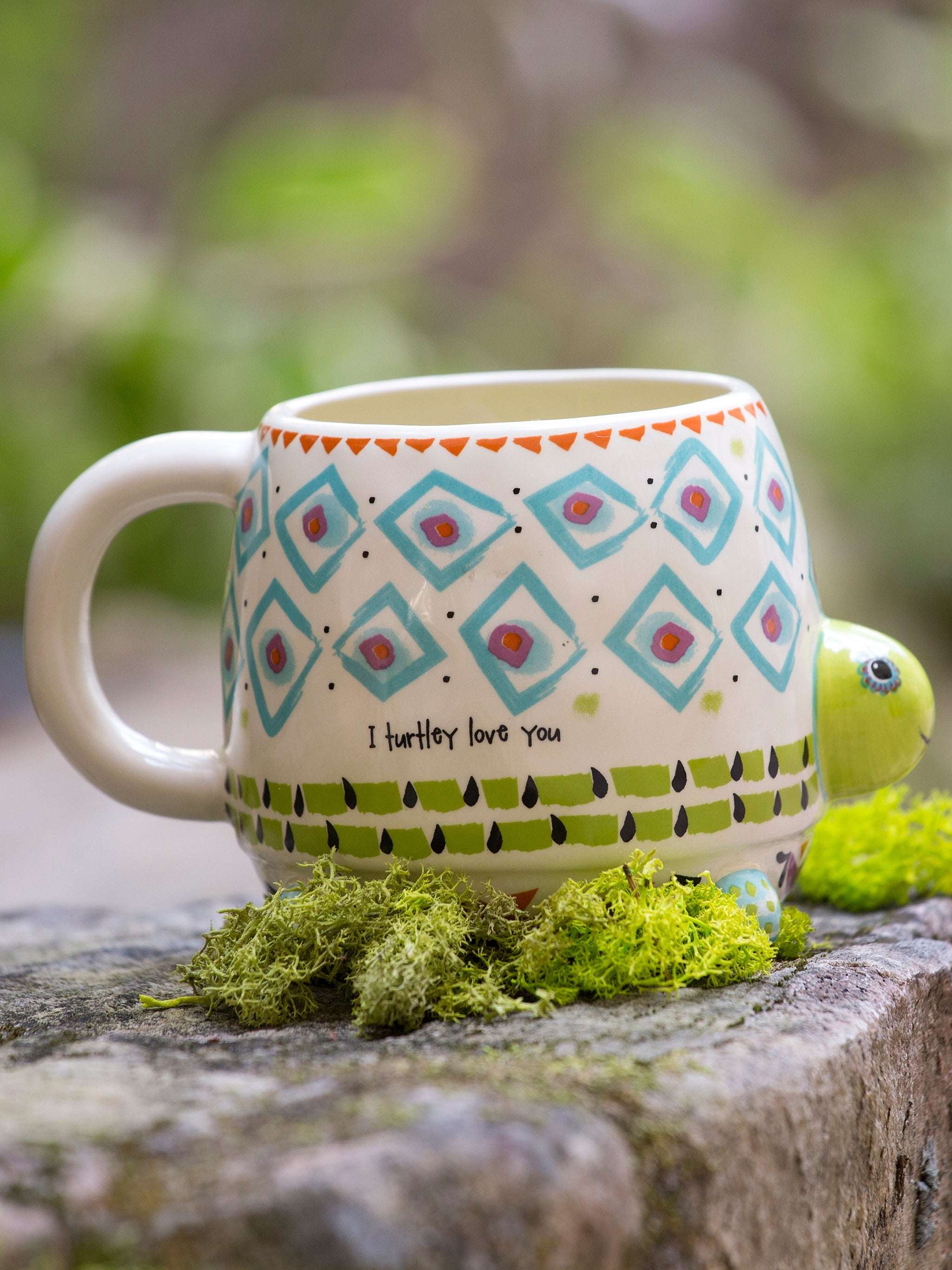 Decorative mug with turtle design on a natural background