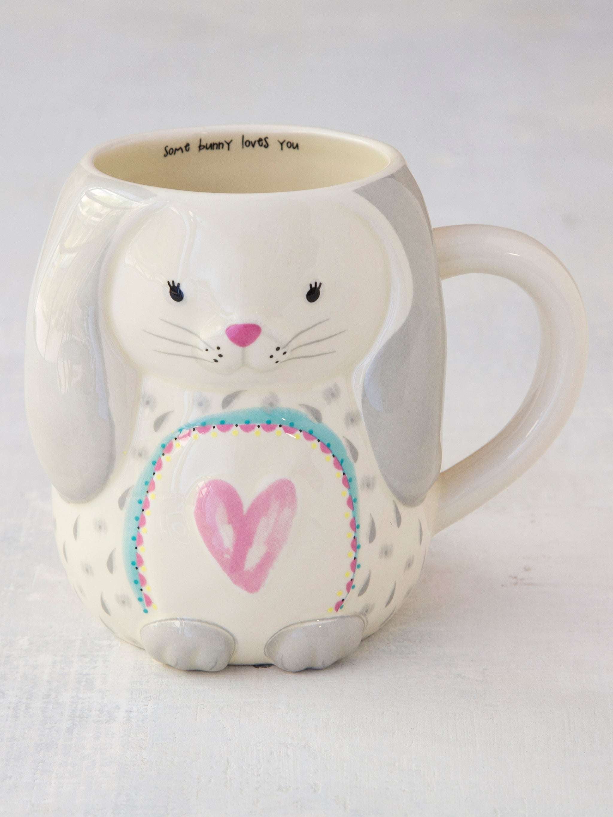 Ceramic mug shaped like a bunny with a pink heart on a white background