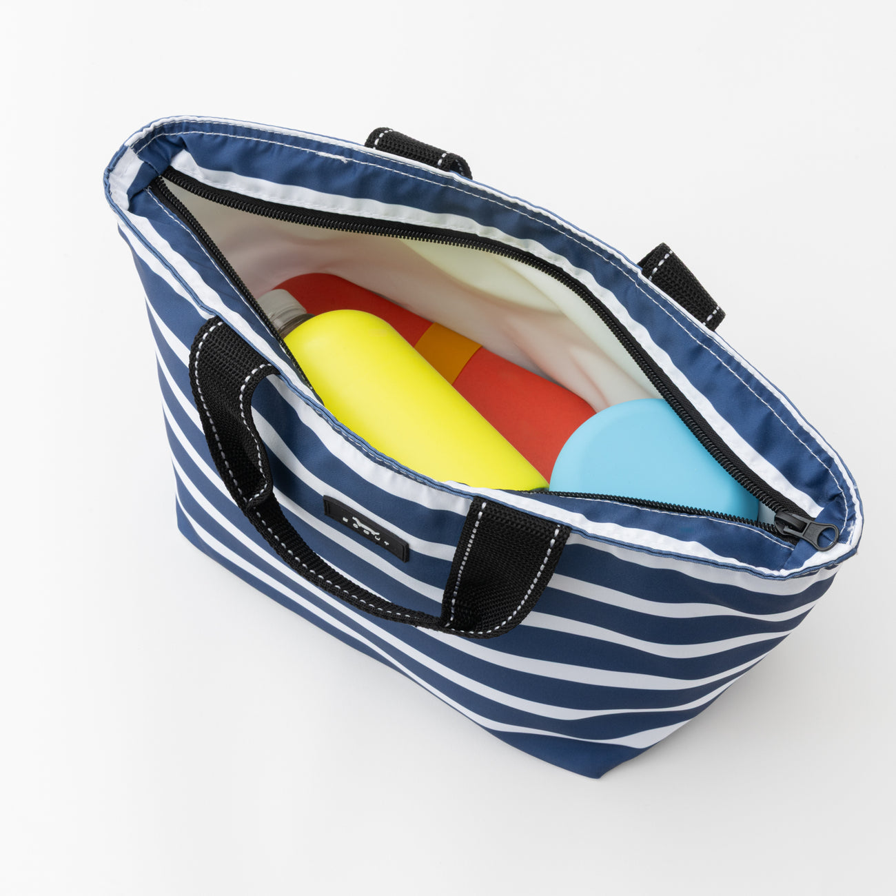 Blue and white striped tote bag with colorful items on a white background