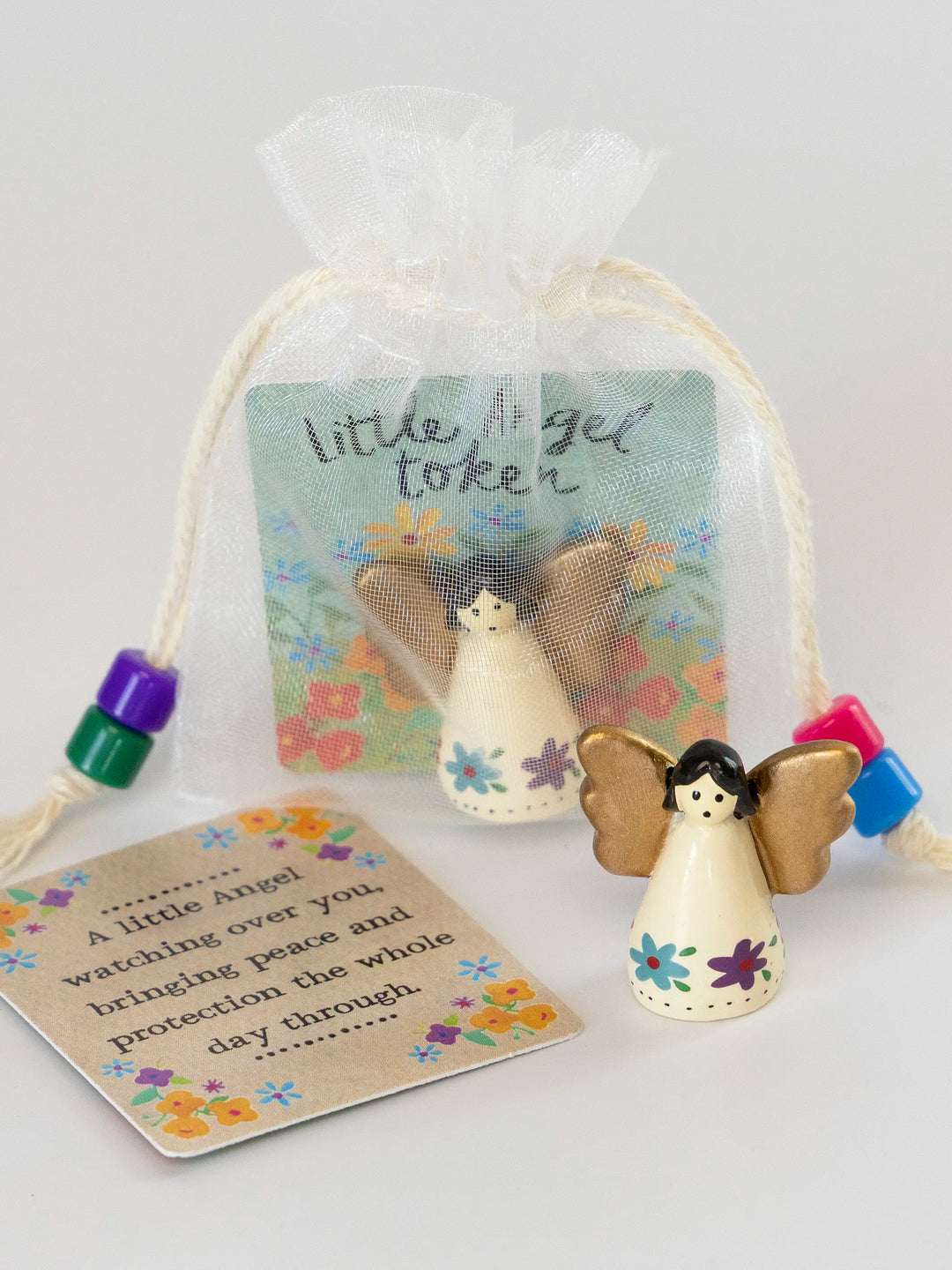Decorative angel token with a card on a white background