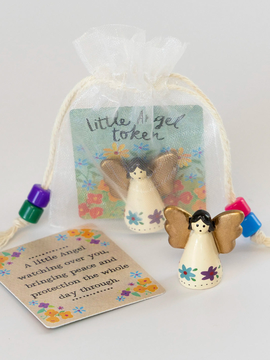 Decorative angel token with a card on a white background