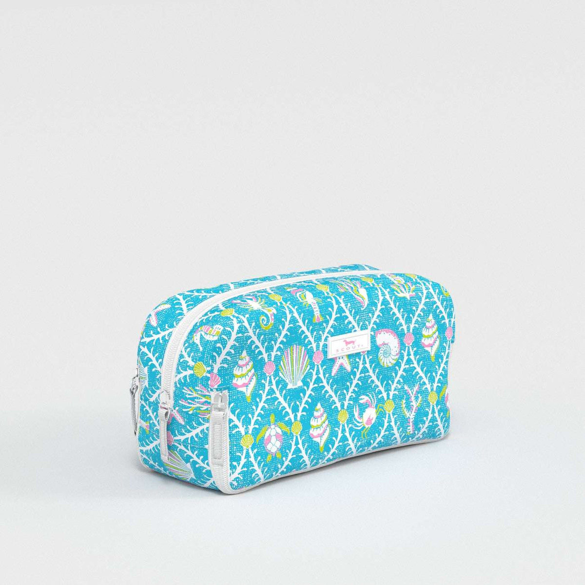 Blue toiletry bag with colorful pattern on a light gray background