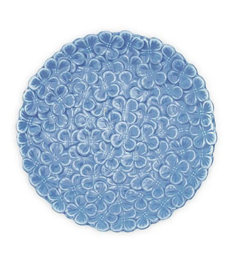 A round blue porcelain dish with a floral pattern around the border.