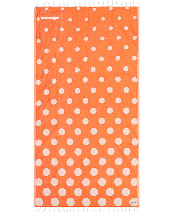 Orange towel with white polka dots on a white background