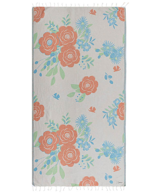 Floral patterned towel with orange and blue flowers on a light background