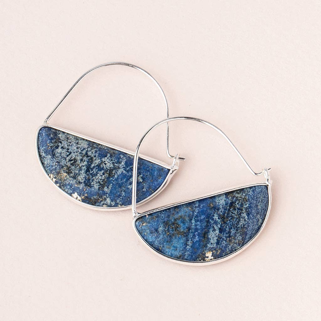 A pair of silver hoop earrings with a semi-precious stone inlaid in the center, displayed against a pink background.