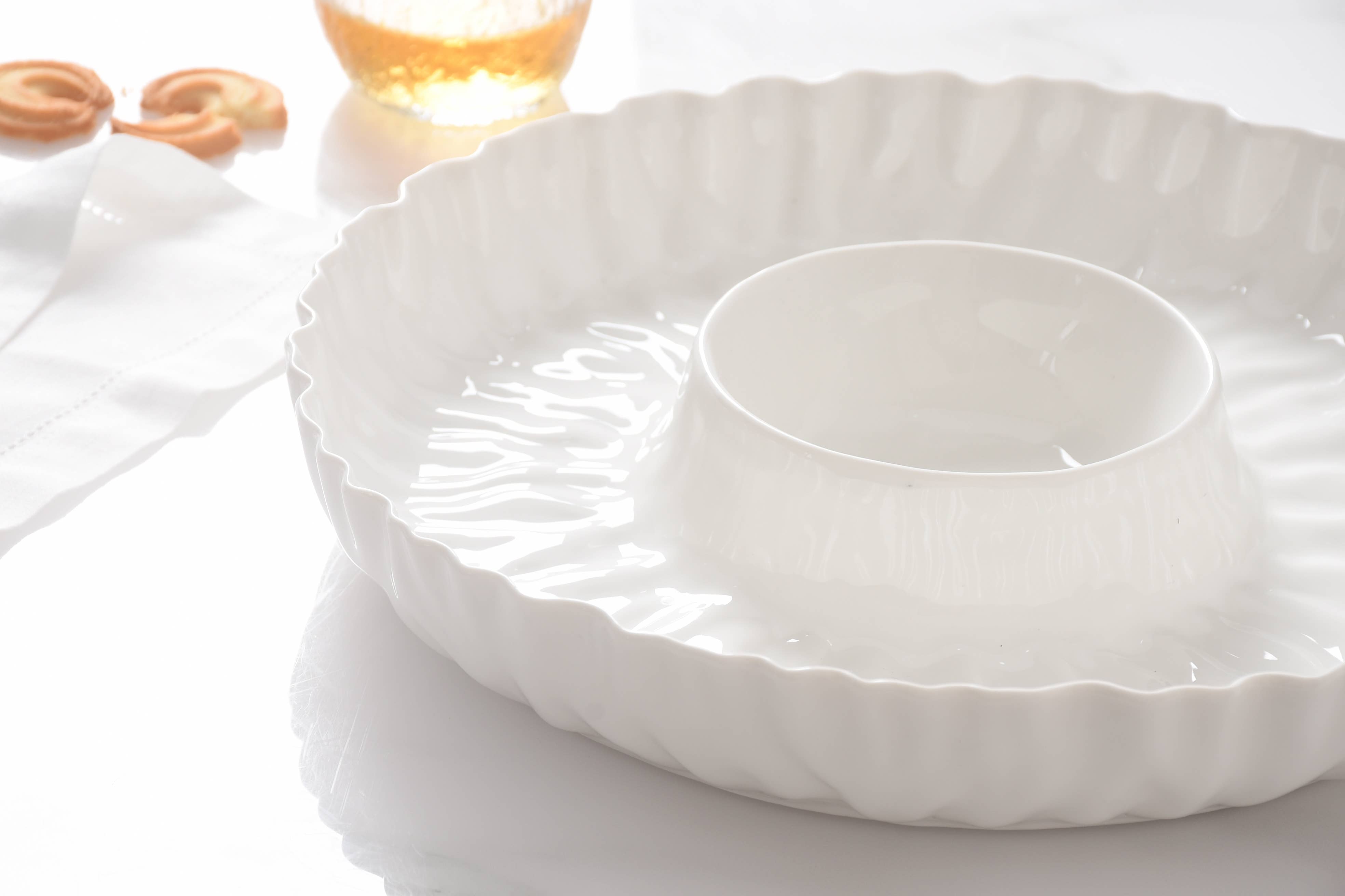 White ceramic dish on a light surface with a blurred background