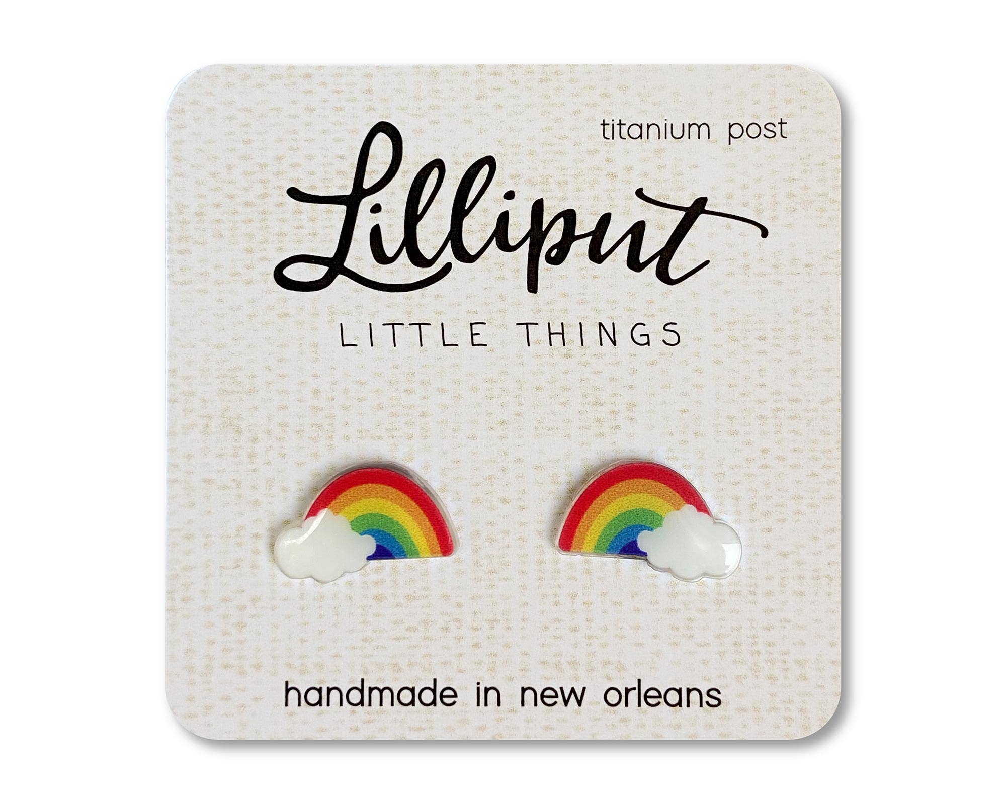 Rainbow-shaped earrings on a Lilliput Little Things branded card.