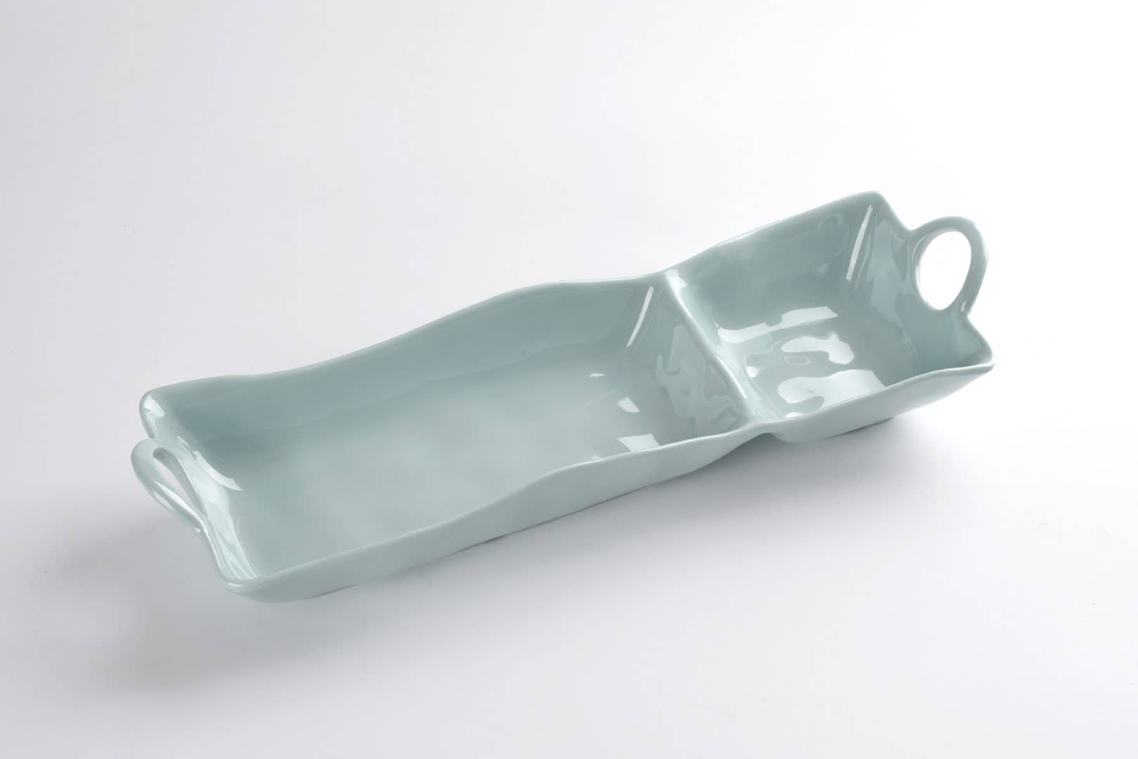 Light blue ceramic tray with handles on a white background