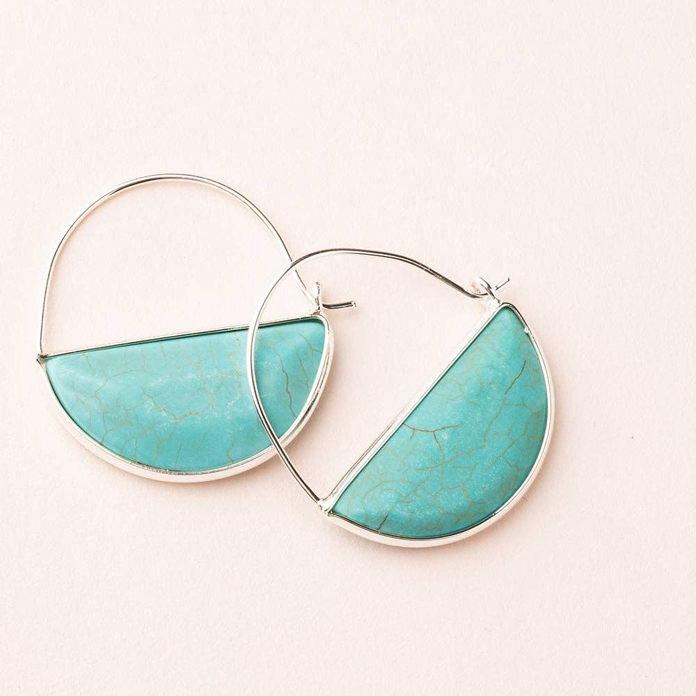 A pair of hoop earrings with a semi-circular turquoise stone set in a silver or gold dipped wire frame, displayed against a light background.