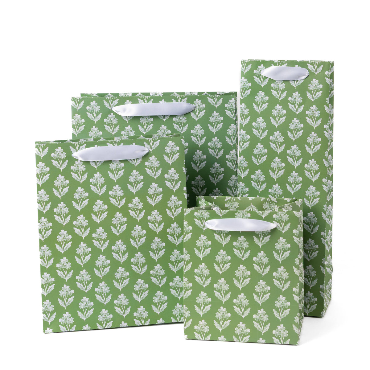 Set of green gift bags with white floral pattern on a white background
