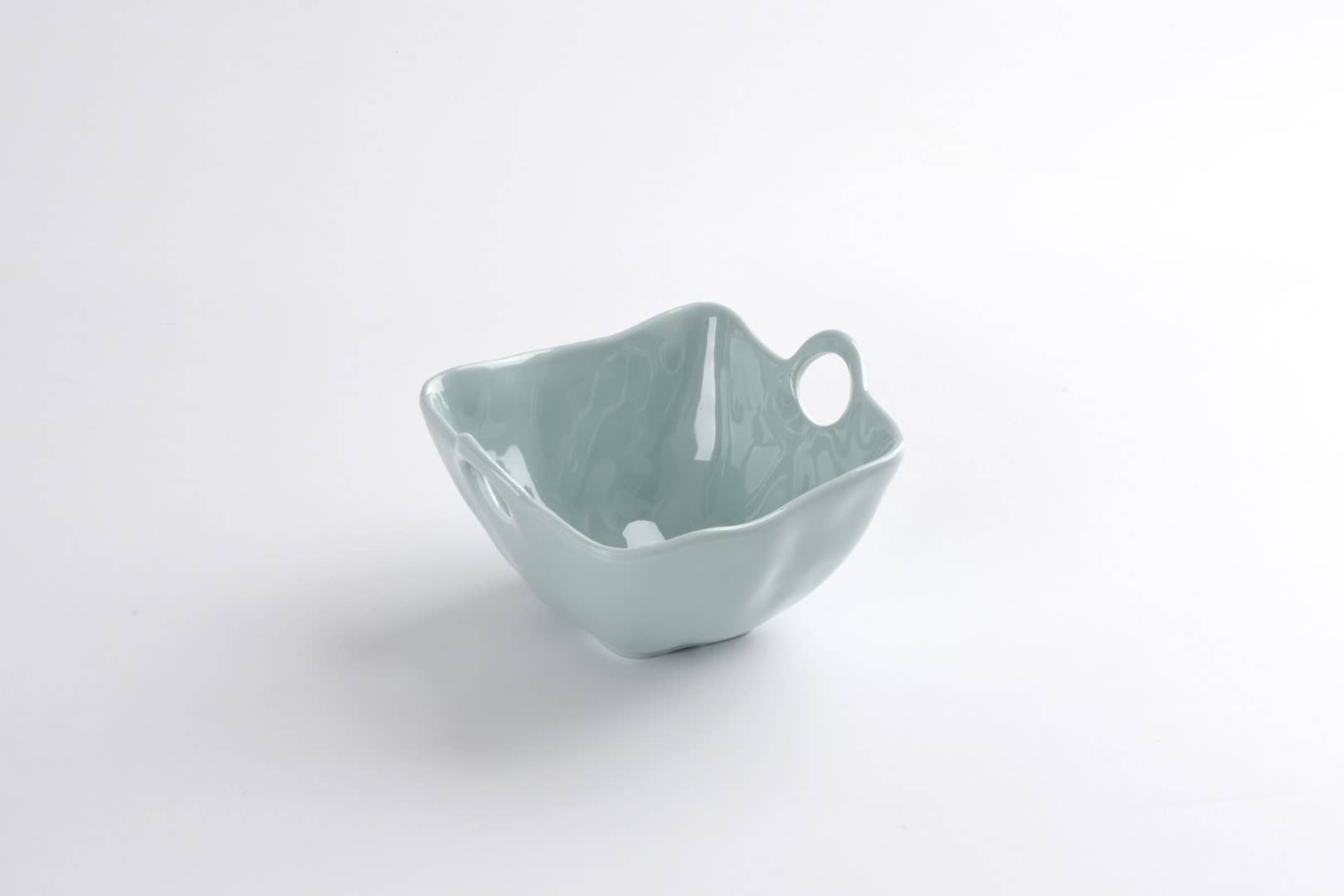 Light blue ceramic bowl with handles on a white background
