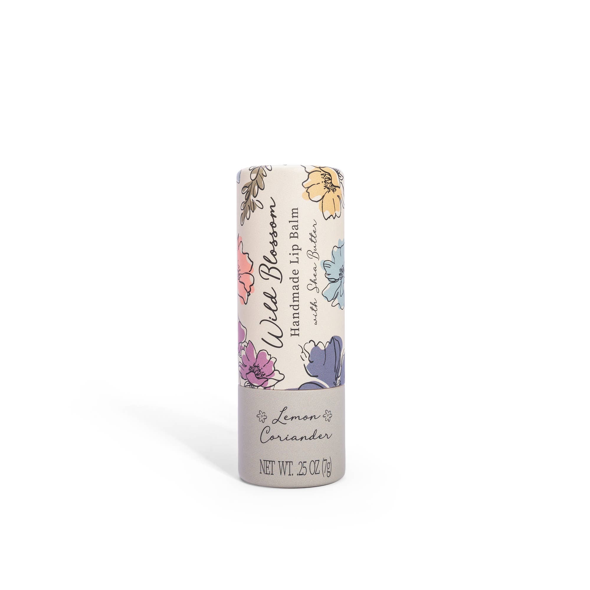 A stick of Wild Blossom Lip Balm with Lemon Coriander flavor, packaged in a cylindrical paperboard container with floral illustrations.