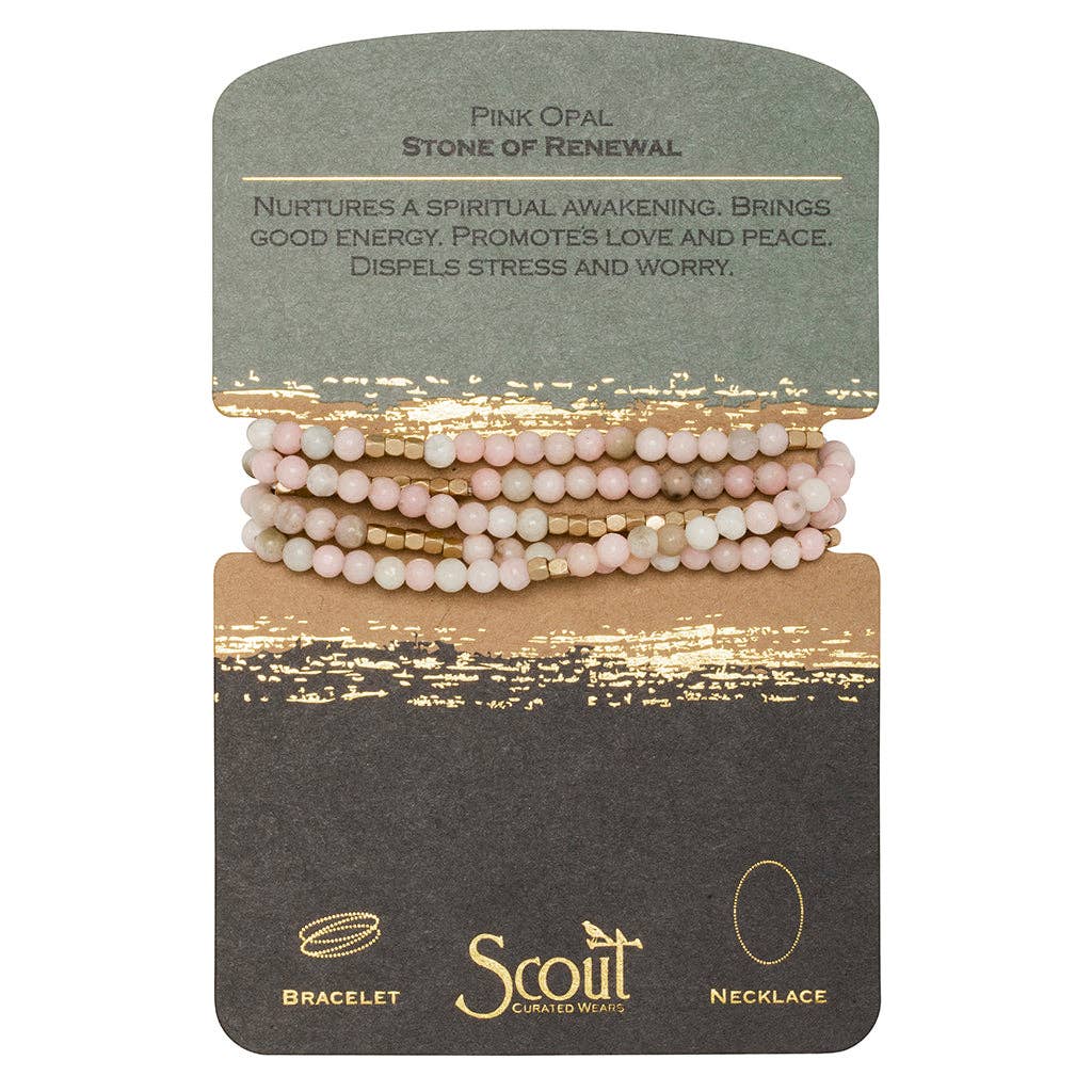 A bracelet made with pink opal beads and gold-colored accents, displayed on a card with the text 'Pink Opal | Stone of Renewal'. The card also features the brand name 'Scout'.