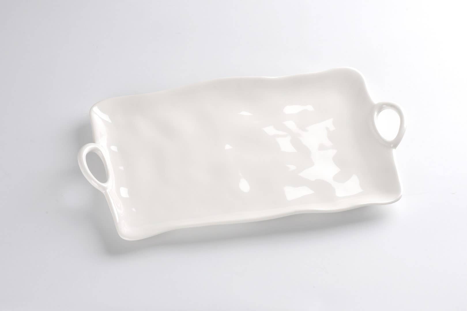 White melamine tray with handles on a light gray background