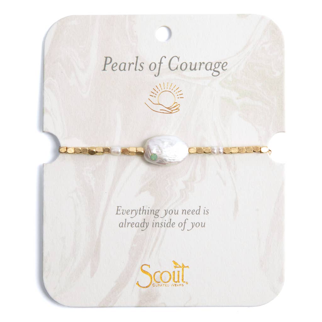 A bracelet with a gold-colored clasp, featuring natural rice pearls and baroque pearl accents, on a card with an affirmation written on it.