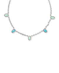 A silver-toned chain necklace featuring five small oval light green stones and one larger marquise-cut light blue stone, displayed on a clean white background.