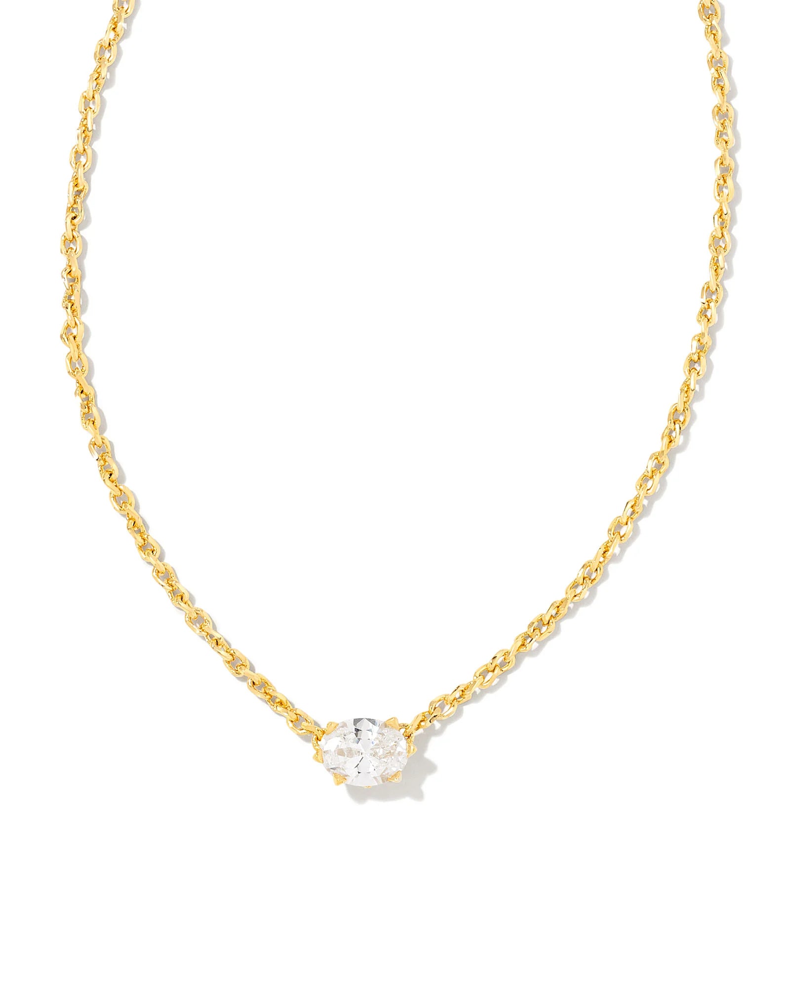 Gold necklace with a clear gemstone on a white background