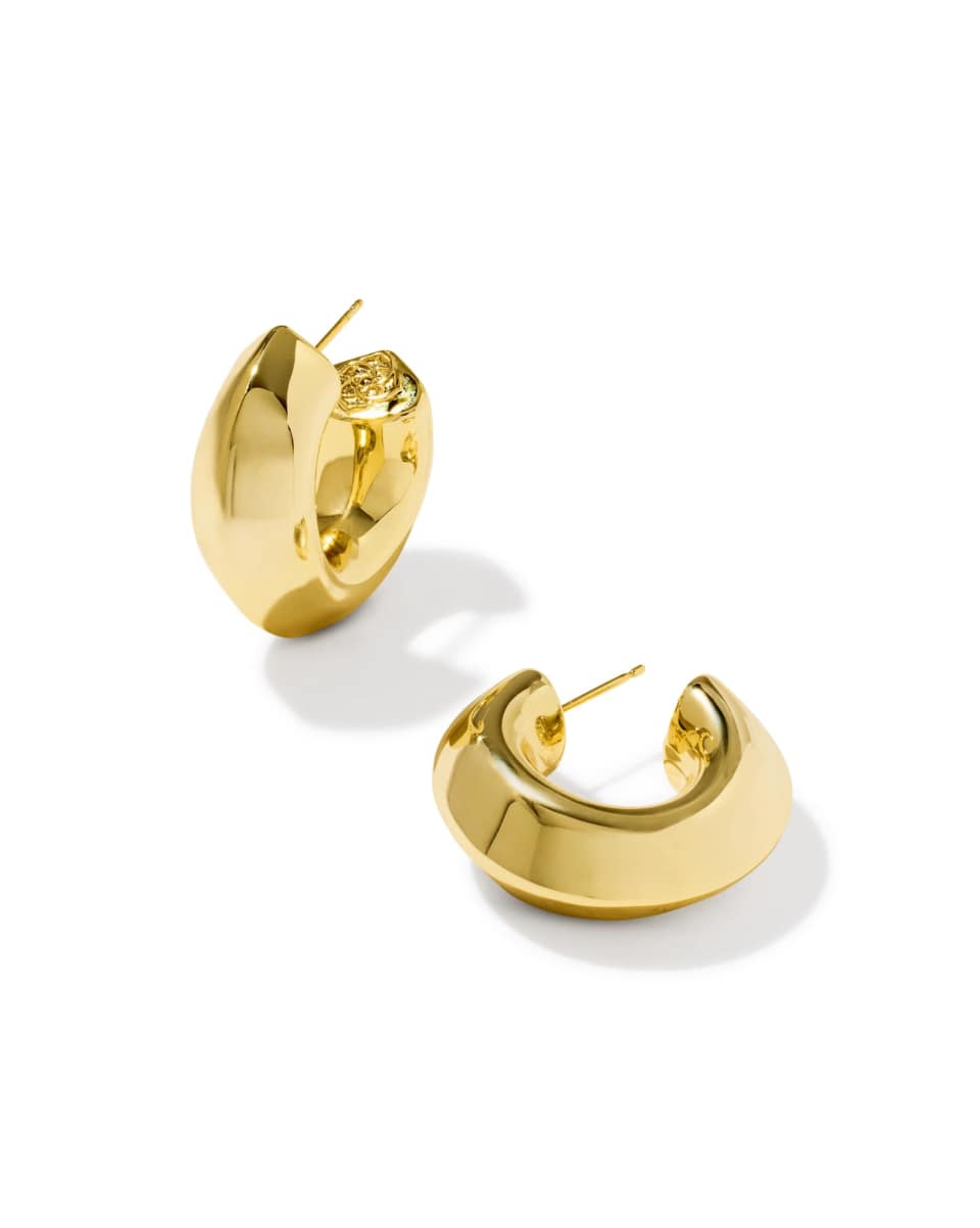 A pair of chunky, polished gold huggie hoop earrings on a clean white background.