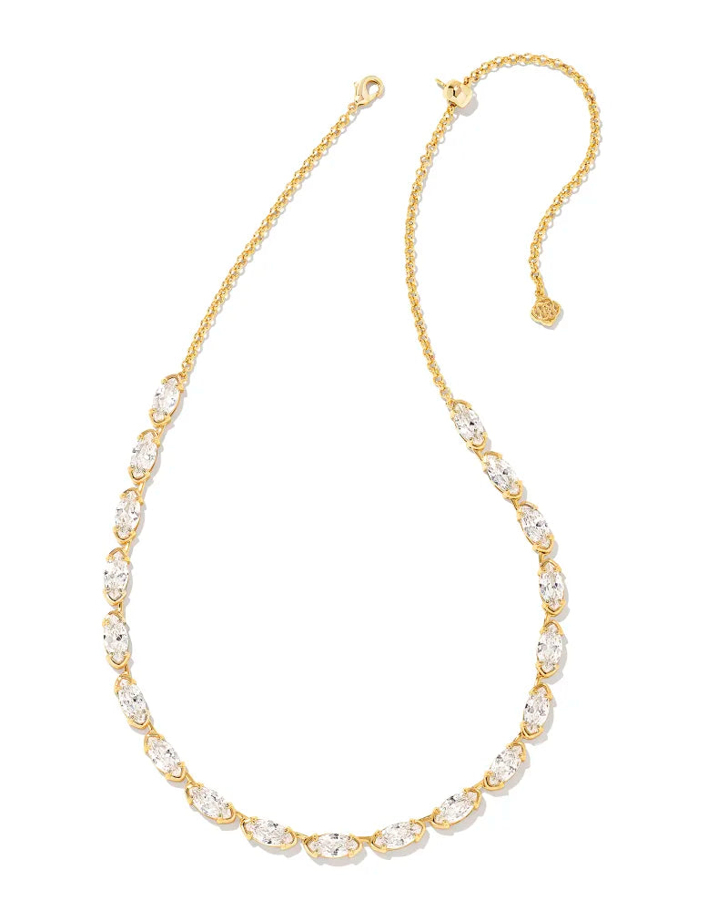A gold-colored strand necklace featuring a series of round white crystals attached to a chain.