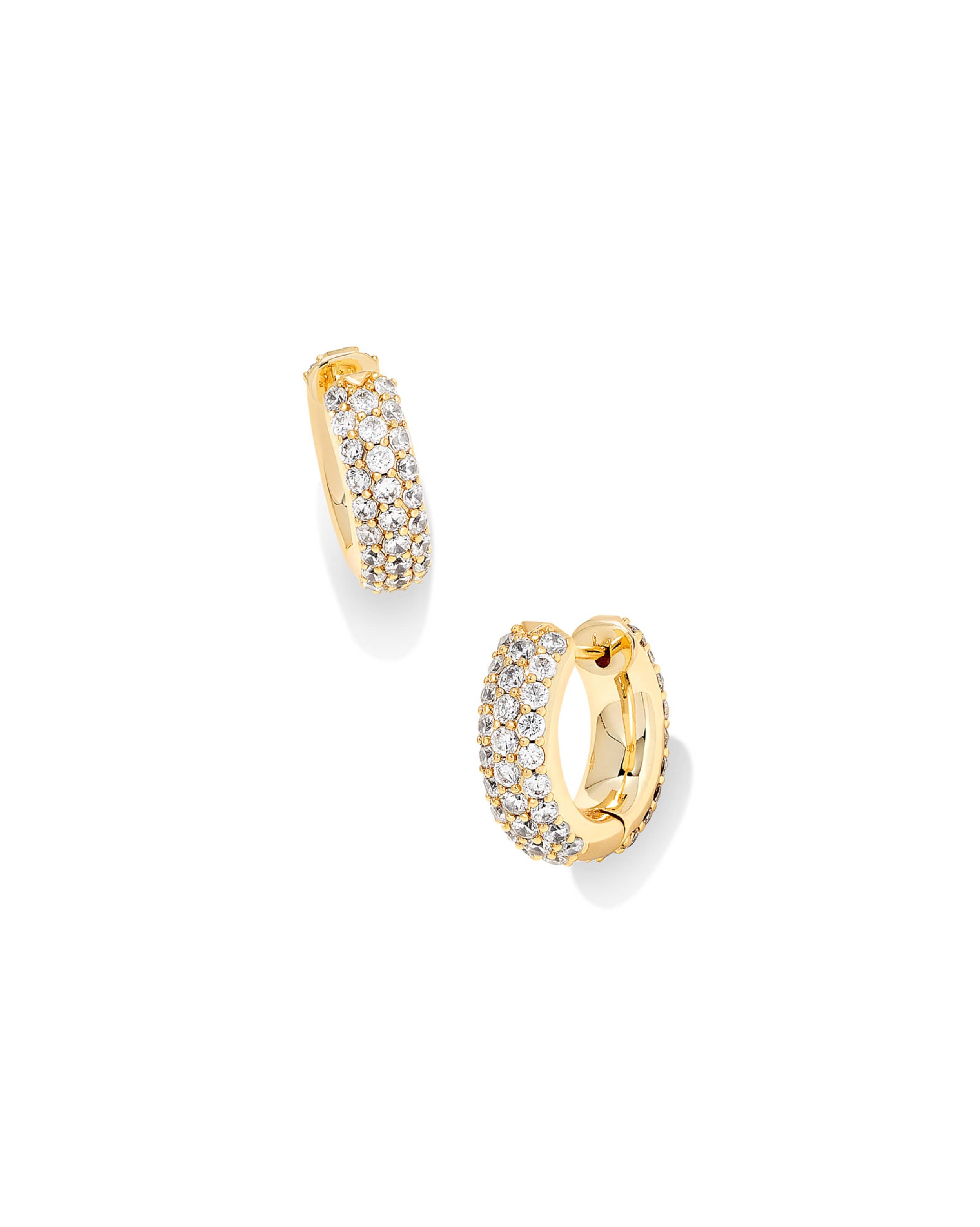 Gold hoop earrings with embedded crystals on a white background