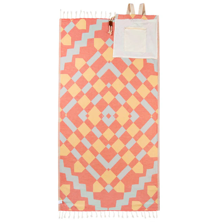 A multicolored geometric patterned towel bag laid flat with twisted tassels and a visible inside zip pocket.
