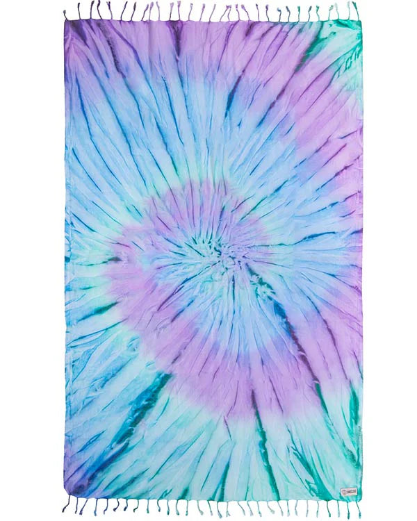 A tie-dye beach towel with predominantly blue and purple colors, laid out flat.
