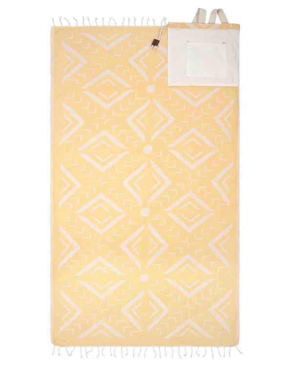 A yellow and white geometric patterned towel bag with twisted tassels and white cotton webbing straps.