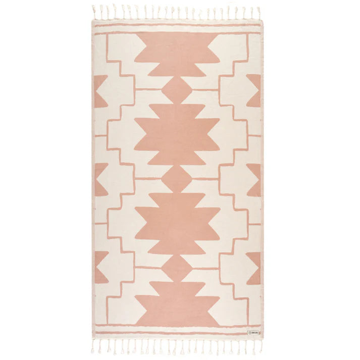 A rectangular towel with a geometric pattern in beige and pink colors, featuring twisted tassels along the edges.